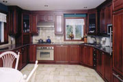 U-shaped kitchen with dark wood cabinetry