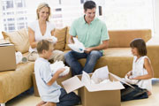 familly unpacking boxes in their dream home