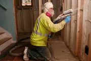 man adding foam insulation to a home man adding foam insulation to a home