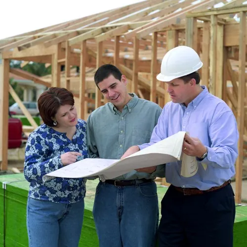 Couple reviewing blueprint Couple looking at house blueprints