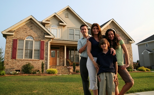family in front of their dream home