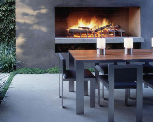 contemporary style outdoor fireplace and dining area
