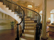 The staircase sweeps in a broad curve from one level to the next