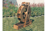 Wood water wheel adds charm to the backyard of a rustic or country house plan