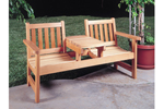 All wood twin-seater has center built-in table for drinks and snacks