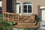 Low-level deck has a portion with a railing and shallow steps to the ground level
