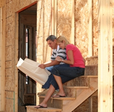 Couple in construction site for a new home